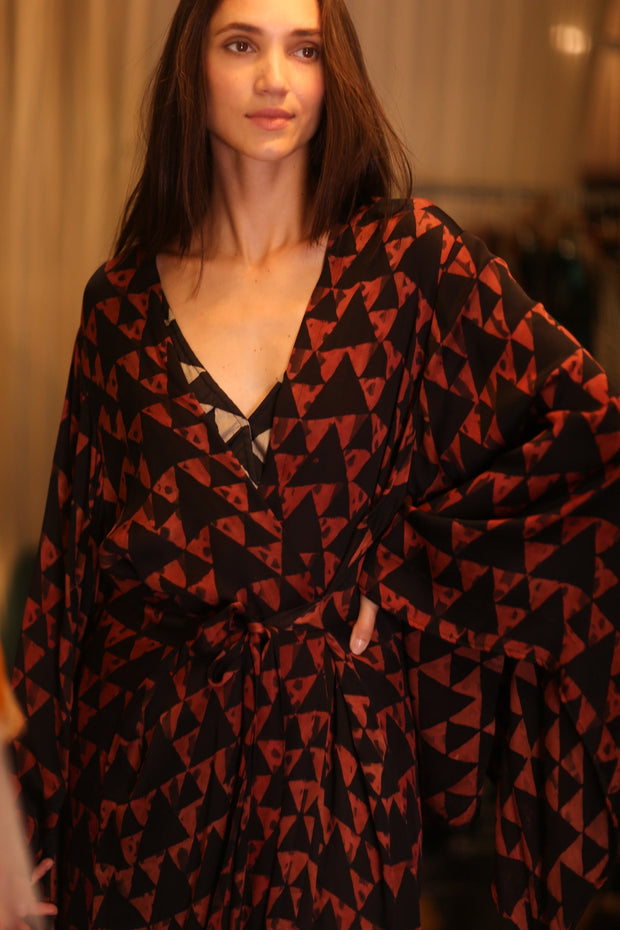 Woman wearing a black and red patterned dress Kimono indoors